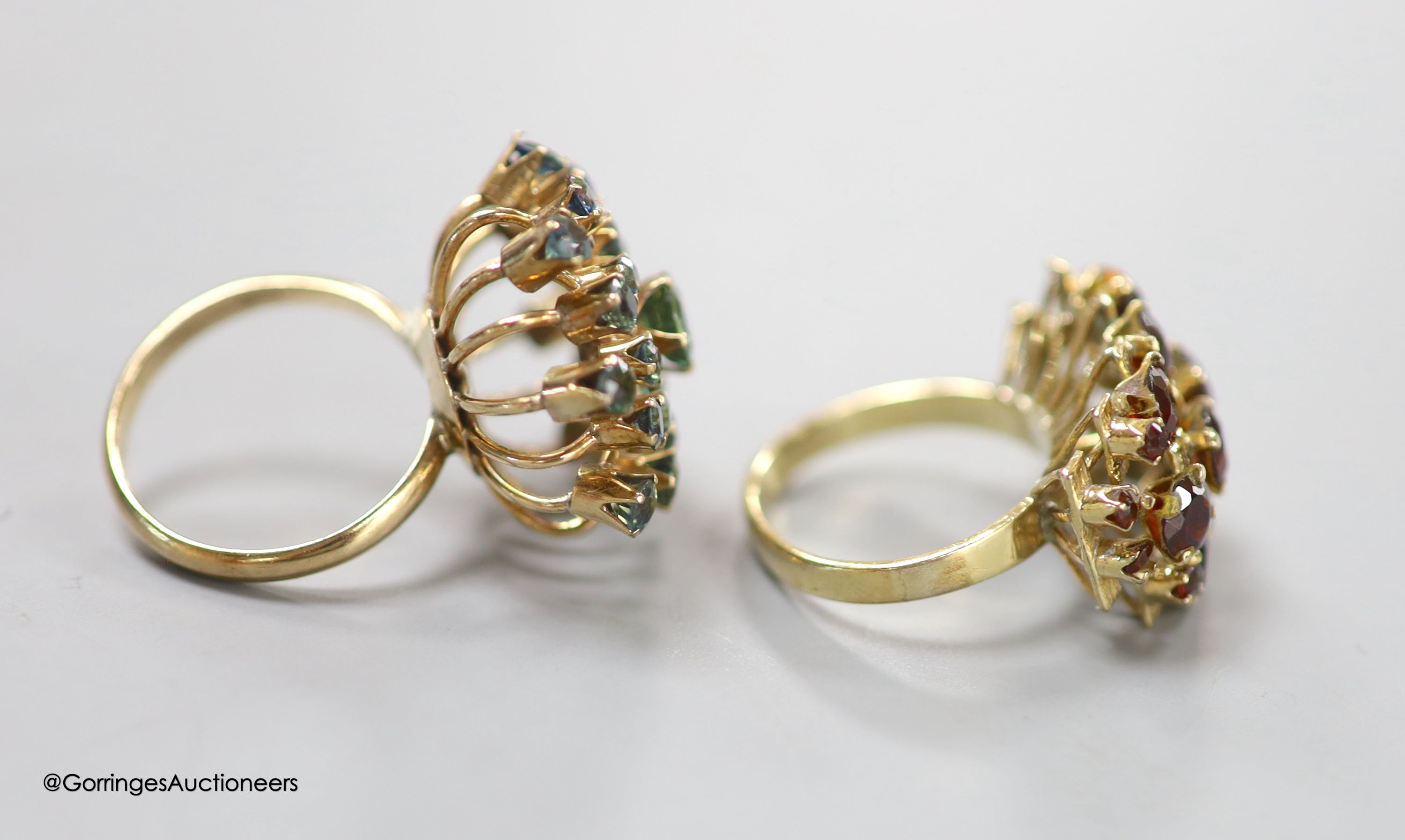 Two modern 14k and gem set cluster dress rings, including garnet, sizes K/L & M, gross 11.2 grams.
